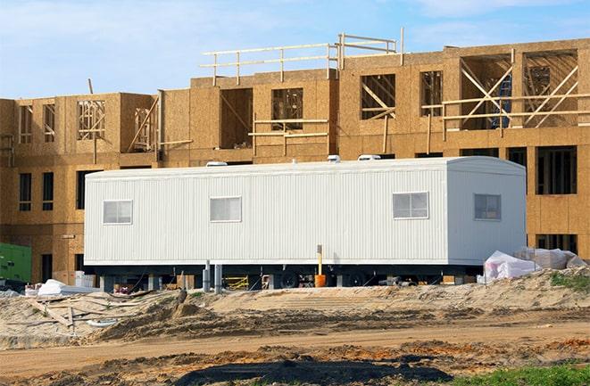 crane lifting modular building for construction office rentals in Lyman